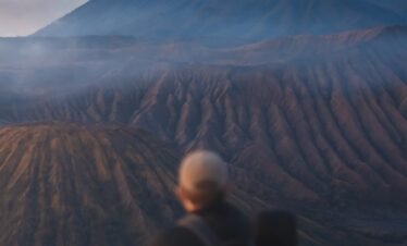 a couple of people standing on top of a mountain