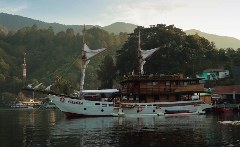 a large white boat floating on top of a lake