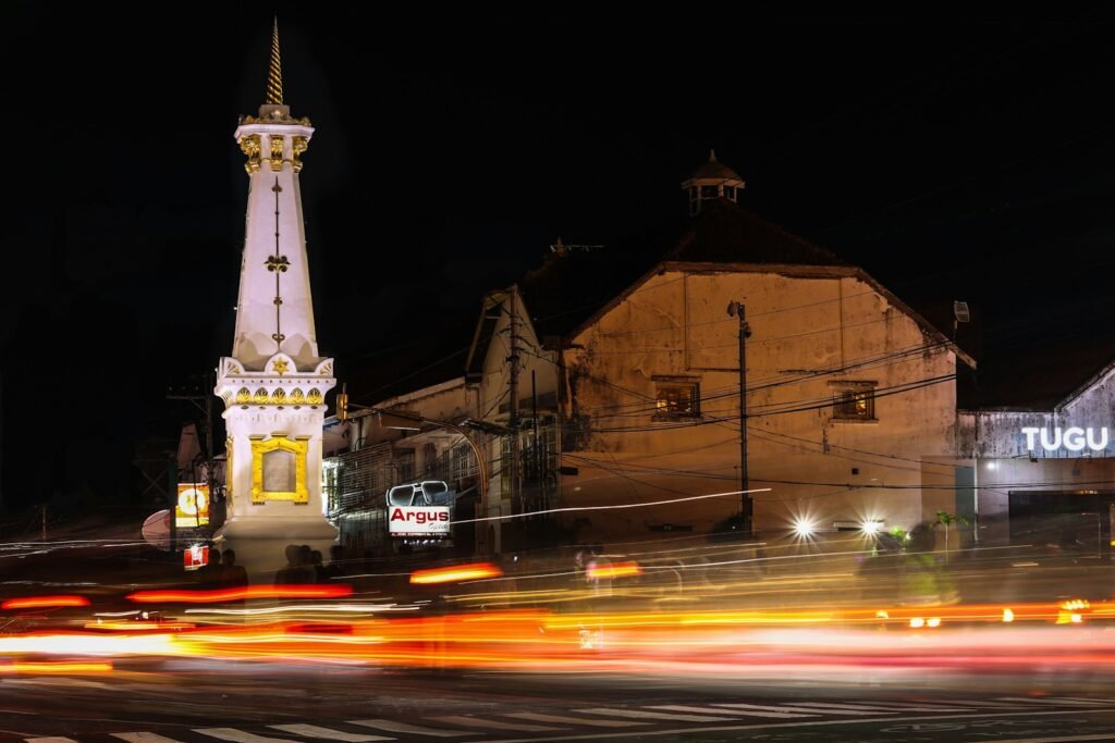 a very tall clock tower towering over a city at night