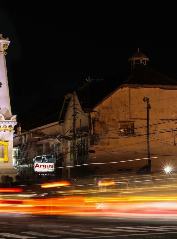 a very tall clock tower towering over a city at night