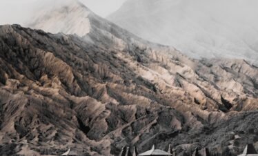person riding horse near mountain range