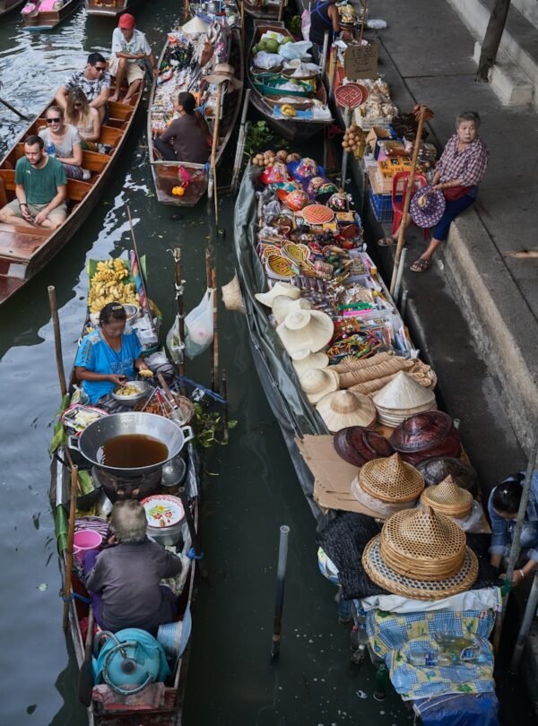 a group of people sitting on boats in a body of water