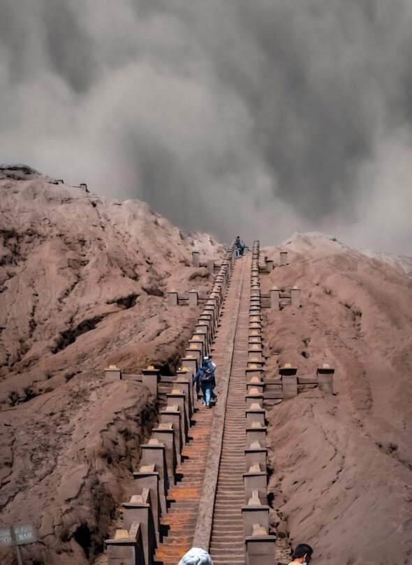 people walking on brown rocky mountain during daytime