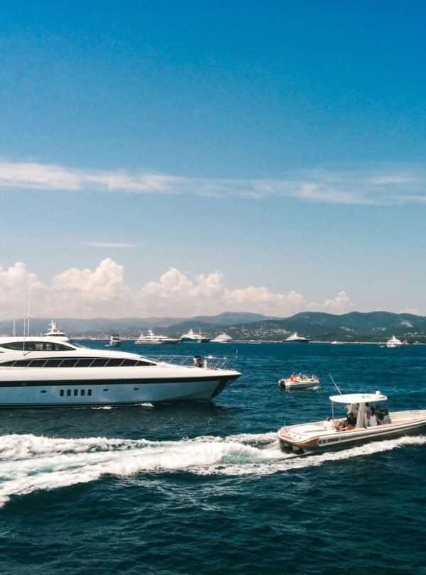 white and blue boat on sea under blue sky during daytime