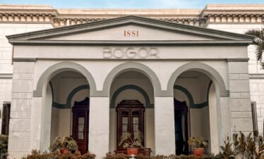 a large white building with a clock on the front of it
