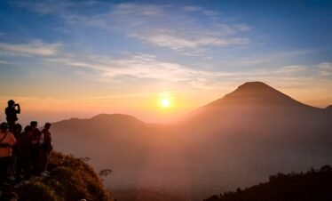 a group of people standing on top of a mountain