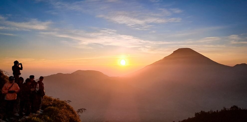 a group of people standing on top of a mountain
