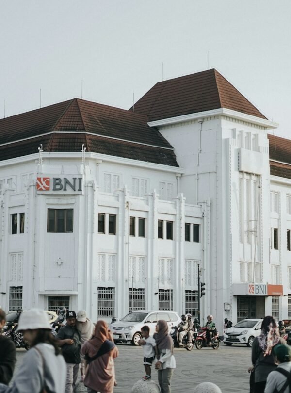 a large white building with a lot of people walking around it
